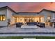 Inviting covered patio area with comfortable seating, a modern fireplace, and a built-in grill at 6301 N 16Th Dr, Phoenix, AZ 85015