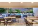 Covered patio boasts ample seating and outdoor kitchen, perfect for entertaining with a view of the pool at 6301 N 16Th Dr, Phoenix, AZ 85015