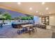 Entertain on the patio with dining, lounging, and cooking areas overlooking the backyard pool and sports facilities at 6301 N 16Th Dr, Phoenix, AZ 85015