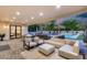 Spacious covered patio with living and dining areas overlooking the pool and meticulously kept backyard at 6301 N 16Th Dr, Phoenix, AZ 85015
