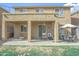 A covered patio, hanging swing chair, and patio furniture for outdoor entertaining and relaxation at 6749 W Charter Oak Rd, Peoria, AZ 85381