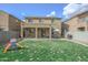 The backyard features a patio, green grass, and a play structure, enclosed by block wall fencing at 6749 W Charter Oak Rd, Peoria, AZ 85381