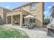 This backyard has a covered patio, outdoor dining area, patio and well manicured lawn at 6749 W Charter Oak Rd, Peoria, AZ 85381