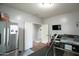 Spacious bonus room with double doors, and stainless steel refrigerator, great for entertaining at 6749 W Charter Oak Rd, Peoria, AZ 85381