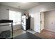 Bonus room includes a refrigerator, fitness equipment, and a convenient door to another room at 6749 W Charter Oak Rd, Peoria, AZ 85381