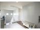 Bright hallway with dark floors, neutral walls, and a cozy sitting bench at 6749 W Charter Oak Rd, Peoria, AZ 85381