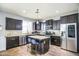 Bright kitchen boasts stainless steel appliances and a convenient center island with seating at 6749 W Charter Oak Rd, Peoria, AZ 85381