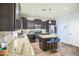 Modern kitchen featuring dark cabinets, granite countertops, and stainless steel appliances at 6749 W Charter Oak Rd, Peoria, AZ 85381