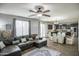 Open floor plan showcasing a living room with a ceiling fan and an adjacent dining area and dark brown kitchen at 6749 W Charter Oak Rd, Peoria, AZ 85381