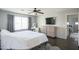 Inviting main bedroom featuring a ceiling fan and dark wood-look floors at 6749 W Charter Oak Rd, Peoria, AZ 85381
