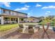 Expansive backyard featuring a covered patio, lounge chairs, lush lawn, mature landscaping, and a sparkling pool at 7354 E Norwood St, Mesa, AZ 85207