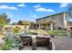 Backyard with pool, outdoor kitchen, lawn and a covered patio with seating at 7354 E Norwood St, Mesa, AZ 85207