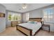 Bright bedroom with a Queen bed, a love seat, and shuttered windows at 7354 E Norwood St, Mesa, AZ 85207