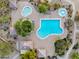 Aerial view of a community pool with multiple pools, shaded areas, and desert landscaping for a relaxing outdoor experience at 7354 E Norwood St, Mesa, AZ 85207