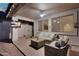 Inviting covered patio area featuring comfortable seating, a ceiling fan, and a mounted television at 7354 E Norwood St, Mesa, AZ 85207