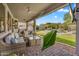 Inviting covered patio with wicker furniture, ceiling fan, and a view of the pool and landscaped backyard at 7354 E Norwood St, Mesa, AZ 85207