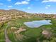 Aerial view of a well-maintained golf course with a lake at 7354 E Norwood St, Mesa, AZ 85207
