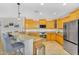 Beautiful kitchen with granite countertops, stainless steel appliances, and bar stool seating at 7354 E Norwood St, Mesa, AZ 85207