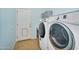Laundry room with front loading washer and dryer, tile floors and access to the backyard at 7354 E Norwood St, Mesa, AZ 85207