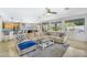 Open-concept living room with a large sectional sofa and view to backyard pool at 7354 E Norwood St, Mesa, AZ 85207
