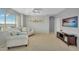 This lounge features a large window, ceiling fan, and neutral colored walls and carpet at 7354 E Norwood St, Mesa, AZ 85207