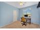 This office features a ceiling fan, a desk and chair, and a bright window at 7354 E Norwood St, Mesa, AZ 85207