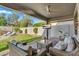 Covered patio with an outdoor television and view of the pool and landscaped backyard at 7354 E Norwood St, Mesa, AZ 85207