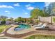Inviting backyard pool with a rock waterfall, lounge chairs and lush landscaping at 7354 E Norwood St, Mesa, AZ 85207