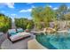 Gorgeous backyard pool featuring a waterfall, surrounded by lush landscaping and lounge seating at 7354 E Norwood St, Mesa, AZ 85207