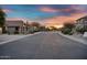 Neighborhood street view with desert landscaping and vibrant sunset at 7354 E Norwood St, Mesa, AZ 85207