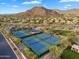 Aerial view of tennis courts in a community with mountain views at 7354 E Norwood St, Mesa, AZ 85207