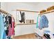 This walk-in closet features ample storage with hanging racks and shelves at 7354 E Norwood St, Mesa, AZ 85207