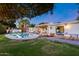 Beautiful backyard oasis featuring a sparkling pool, patio furniture, manicured lawn and lush palm trees at 7820 N 5Th Ave, Phoenix, AZ 85021