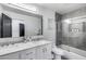 The spacious bathroom has a double vanity and a glass-enclosed shower/tub at 7820 N 5Th Ave, Phoenix, AZ 85021