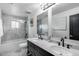 This luxurious bathroom features a double vanity, marble countertops, and a glass-enclosed shower at 7820 N 5Th Ave, Phoenix, AZ 85021