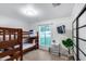 This bedroom offers wood flooring, bunk beds, and a bright window view at 7820 N 5Th Ave, Phoenix, AZ 85021