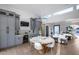 Dining area with a view of the living room, bar, and high windows for natural light at 7820 N 5Th Ave, Phoenix, AZ 85021