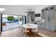Modern dining area with backyard pool views, sleek furniture, and a custom bar at 7820 N 5Th Ave, Phoenix, AZ 85021