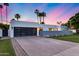 Modern home showcasing a sleek design, large garage door, and neatly landscaped front yard at 7820 N 5Th Ave, Phoenix, AZ 85021