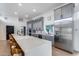 Modern kitchen with a large island, stainless steel appliances, and custom gray cabinetry at 7820 N 5Th Ave, Phoenix, AZ 85021