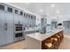 Modern kitchen with sleek gray cabinets, a large island, and stainless steel appliances at 7820 N 5Th Ave, Phoenix, AZ 85021