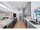 Spacious kitchen with an expansive island, grey cabinets, and open floor plan to living spaces at 7820 N 5Th Ave, Phoenix, AZ 85021