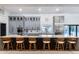 Contemporary kitchen with a large island, seating, built-in appliances, and gray cabinets at 7820 N 5Th Ave, Phoenix, AZ 85021