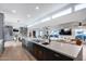 Bright kitchen with quartz counters, gas cooktop, an island with seating, and a view into the living area at 7820 N 5Th Ave, Phoenix, AZ 85021