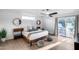 The stylish main bedroom has wood flooring and natural light through sliding glass doors at 7820 N 5Th Ave, Phoenix, AZ 85021