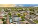 Scenic aerial shot of a neighborhood featuring lush greenery, and mountain views in the distance at 8229 E Devonshire Ave, Scottsdale, AZ 85251