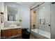 Newly remodeled bathroom boasting walk-in shower, modern tilework, and unique wood accents at 8229 E Devonshire Ave, Scottsdale, AZ 85251