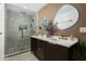 Bathroom featuring modern vanity with double sinks and a walk-in shower at 8229 E Devonshire Ave, Scottsdale, AZ 85251