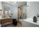 Sleek bathroom features modern tilework, new fixtures, lighted mirror, and unique glass shower door at 8229 E Devonshire Ave, Scottsdale, AZ 85251