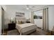 Bright bedroom featuring a ceiling fan, closet, and large window at 8229 E Devonshire Ave, Scottsdale, AZ 85251